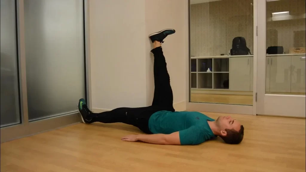 lying hamstring stretch using a wall